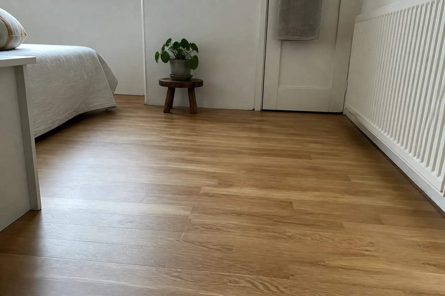 Slaapkamer met een warme eiken lamelparketvloer